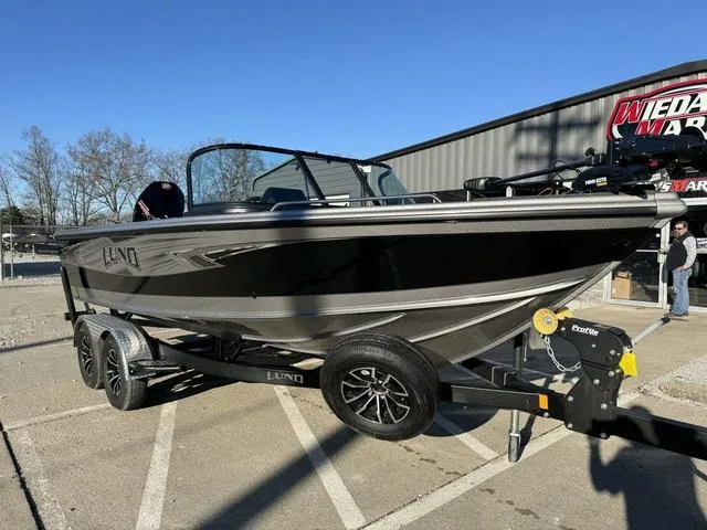 Slide: The Image of 2024 Lund 1975 Tyee Sport boat on trailer, parked outdoors. - 8