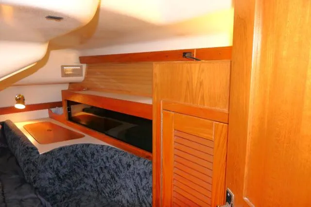 Slide: The Image of Interior cabin of 1997 Catalina 380 sailboat with wood paneling and cozy seating. - 14