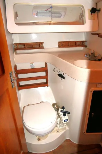 Slide: The Image of 1997 Catalina 380 yacht bathroom with compact toilet and sink. - 18