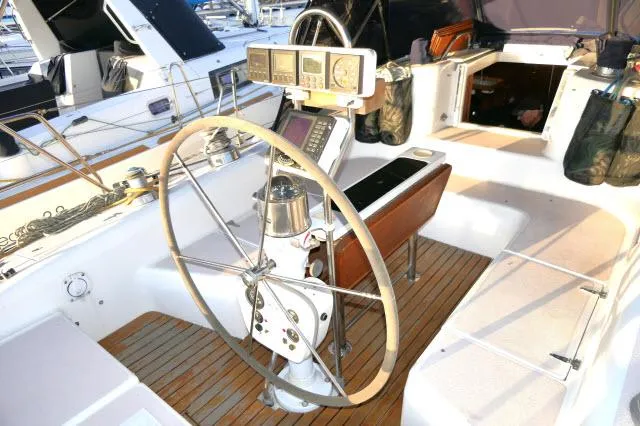 Slide: The Image of Cockpit of a 1997 Catalina 380 sailboat with steering wheel and navigation instruments. - 19