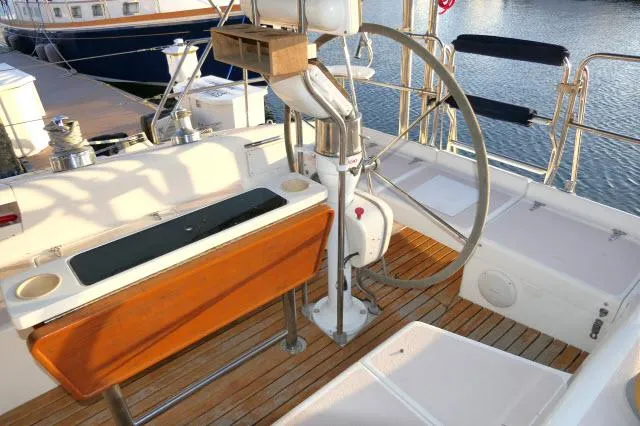 Slide: The Image of Cockpit of 1997 Catalina 380 sailboat with wooden seating and steering wheel. - 22