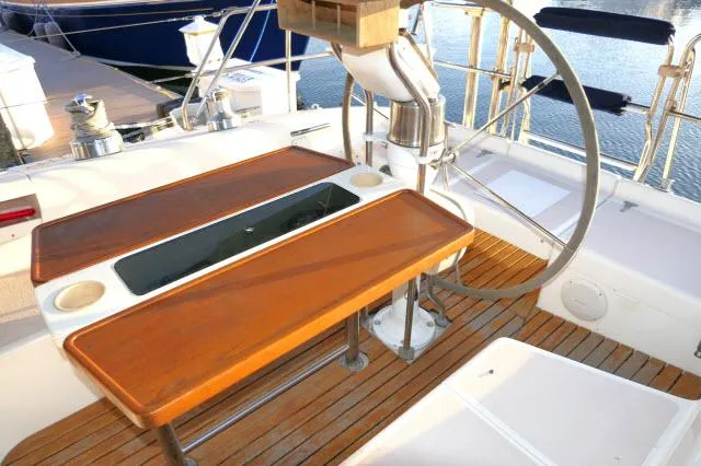 Slide: The Image of Cockpit of 1997 Catalina 380 sailboat with wooden table and steering wheel. - 23