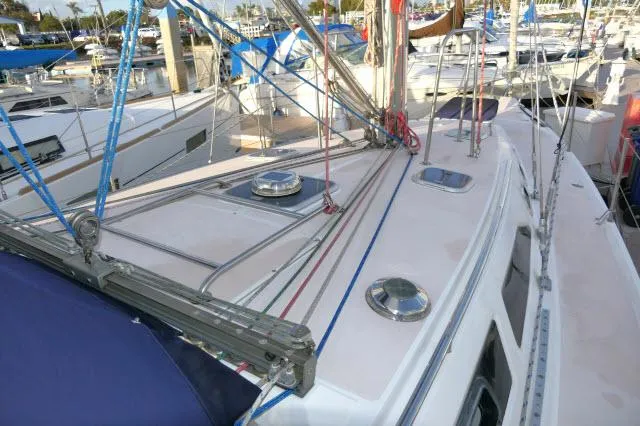Slide: The Image of Catalina 380 sailboat deck, 1997 model, docked in a marina with rigging and hatches visible. - 33