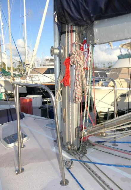 Slide: The Image of 1997 Catalina 380 sailboat deck with rigging and marina background. - 36