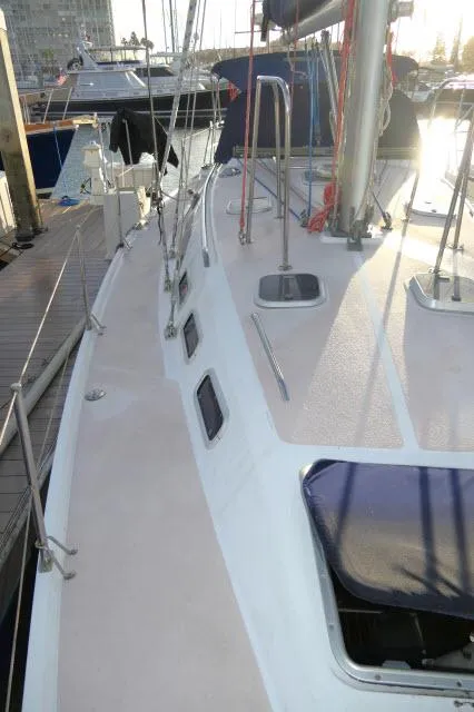 Slide: The Image of 1997 Catalina 380 sailboat docked at marina, showing deck and rigging. - 39
