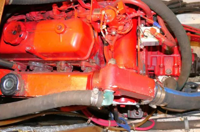 Slide: The Image of Engine of a 1997 Catalina 380 sailboat with red components and hoses. - 45