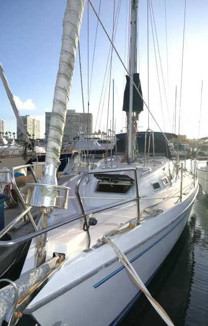 Slide: The Image of 1997 Catalina 380 sailboat docked in marina, showcasing sleek design and rigging. - 46
