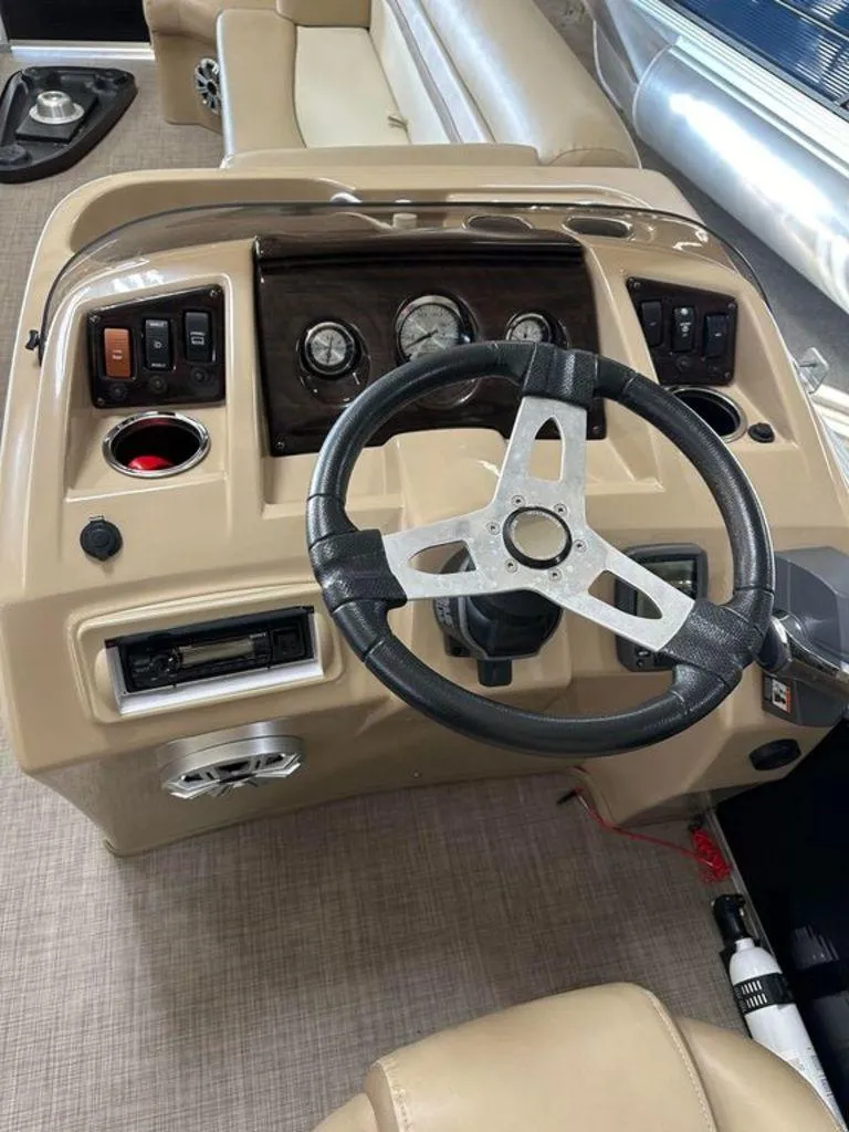 Slide: The Image of Steering console of a 2016 Bennington 24 SLX pontoon boat with gauges and controls. - 11