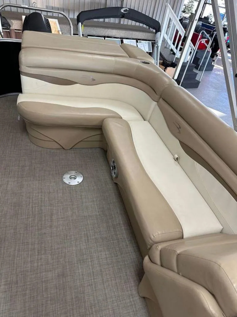 Slide: The Image of 2016 Bennington 24 SLX boat interior with beige and cream seating. - 12