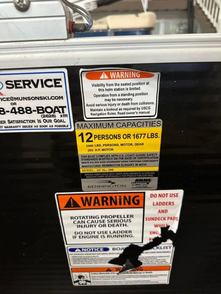 Slide: The Image of Warning and capacity labels on a 2016 Bennington 24 SLX boat. - 15