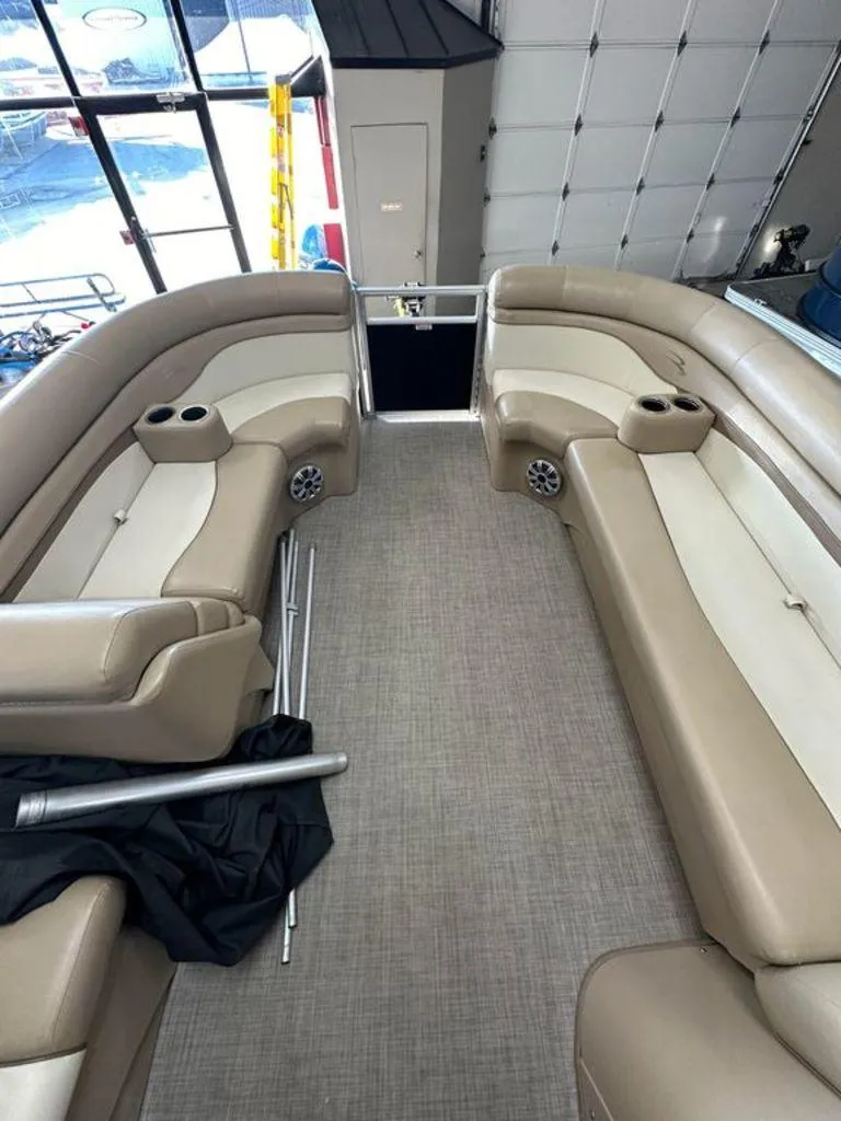 Slide: The Image of Interior of 2016 Bennington 24 SLX pontoon boat with beige seating and cup holders. - 3