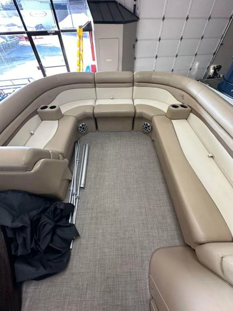 Slide: The Image of Interior seating of a 2016 Bennington 24 SLX pontoon boat in a garage. - 4