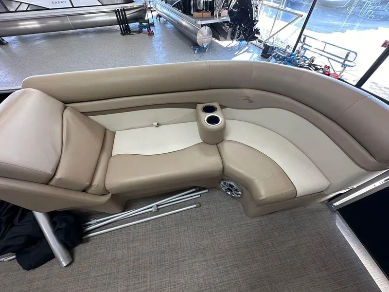 Slide: The Image of 2016 Bennington 24 SLX boat interior with beige and cream seating and cup holders. - 6