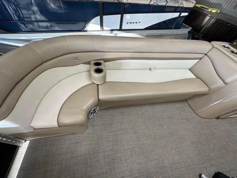 Slide: The Image of 2016 Bennington 24 SLX boat interior with beige and white seating. - 7