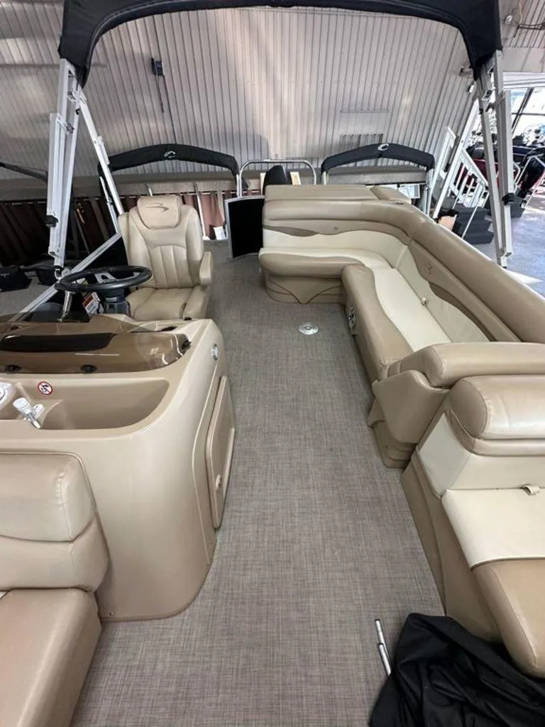 Slide: The Image of 2016 Bennington 24 SLX pontoon boat interior with beige seating and helm. - 8