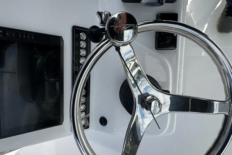 Slide: The Image of 2024 Tidewater 180 CC boat steering wheel and control panel close-up. - 10