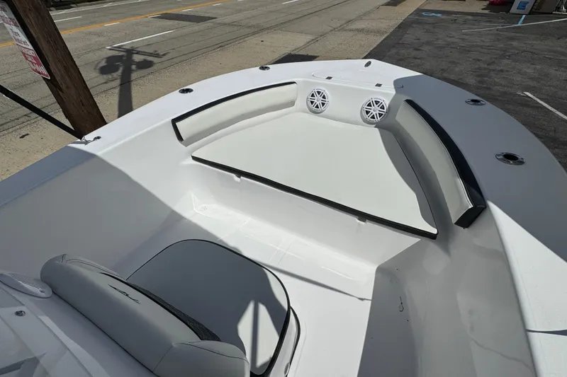 Slide: The Image of 2024 Tidewater 180 CC boat interior with seating and speakers, parked on a street. - 13