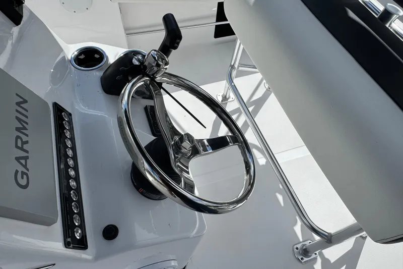 Slide: The Image of 2024 Tidewater 180 CC boat helm with Garmin navigation and steering wheel. - 21