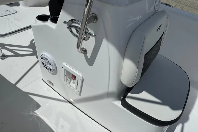 Slide: The Image of 2024 Tidewater 180 CC boat interior with speaker, cup holders, and cushioned seating. - 23