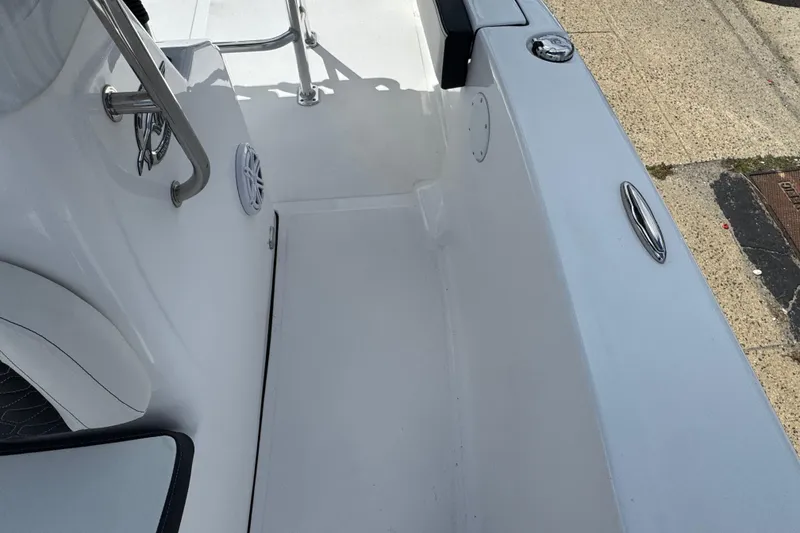 Slide: The Image of 2024 Tidewater 180 CC boat interior, featuring sleek white design and stainless steel fixtures. - 25
