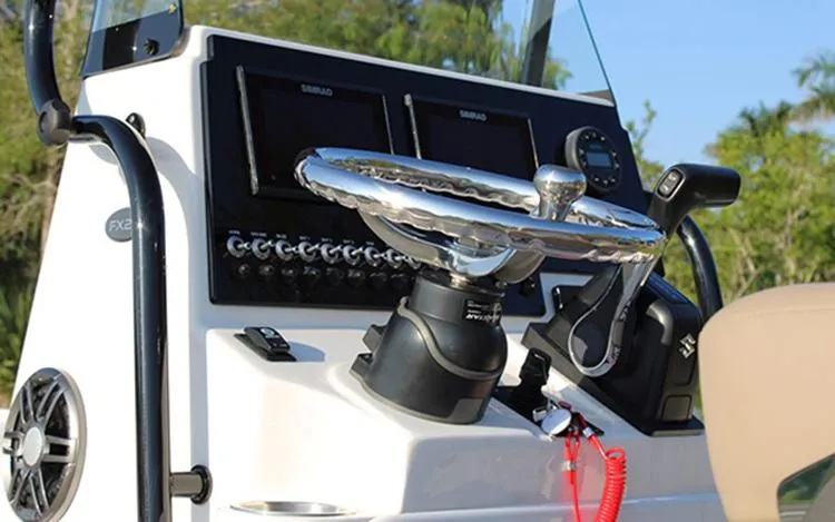 Slide: The Image of 2023 Sea Born FX22 Bay boat console with steering wheel and navigation controls. - 4