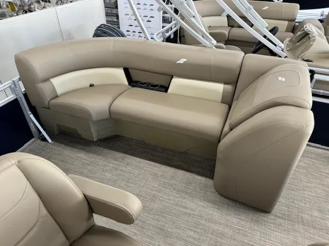 Slide: The Image of 2024 Starcraft LX 18 R pontoon boat interior with beige seating. - 11
