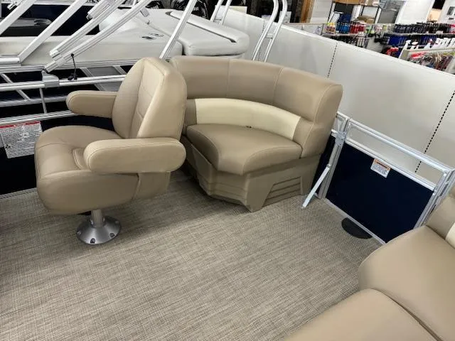 Slide: The Image of 2024 Starcraft LX 18 R pontoon boat interior with beige seating. - 13