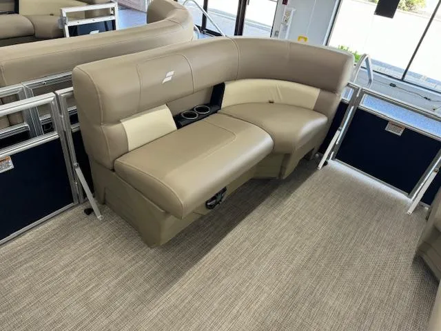 Slide: The Image of 2024 Starcraft LX 18 R pontoon boat interior with beige seating and cup holders. - 5