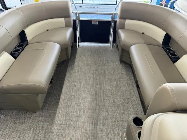 Slide: The Image of Interior of 2024 Starcraft LX 18 R pontoon boat with beige seating and cup holders. - 6