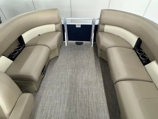 Slide: The Image of 2024 Starcraft LX 20 R boat interior with beige seating and cup holders. - 13