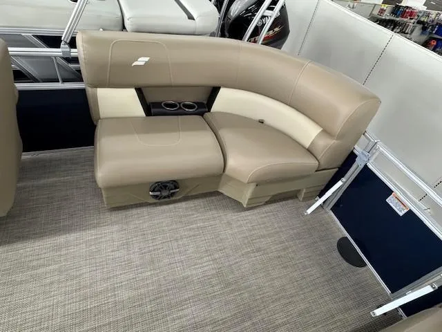 Slide: The Image of 2024 Starcraft LX 20 R boat interior with beige seating and cup holders. - 14