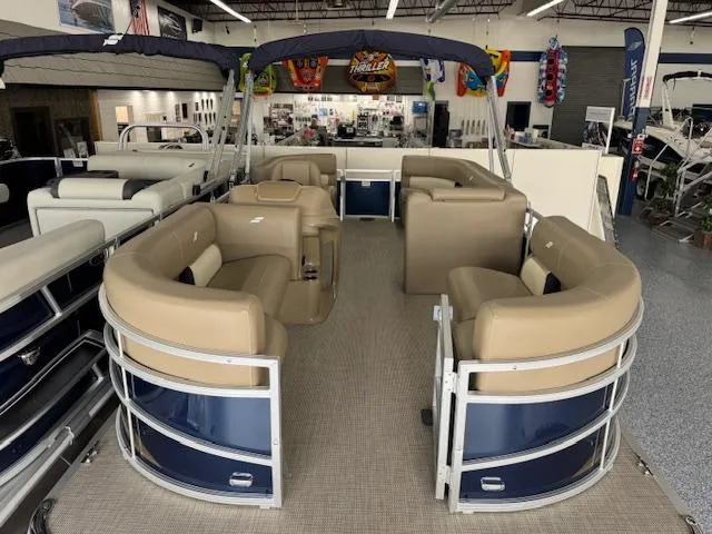Slide: The Image of 2024 Starcraft LX 20 R pontoon boat with beige seating in showroom. - 4