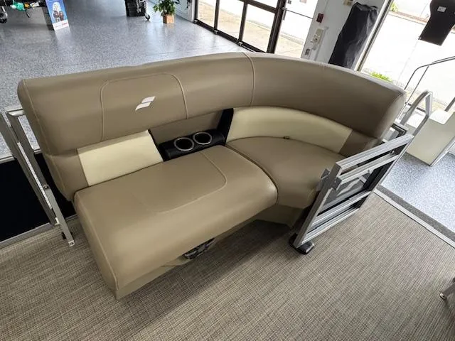 Slide: The Image of 2024 Starcraft LX 20 R boat interior with beige seating and cup holders. - 6
