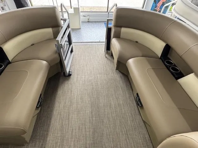 Slide: The Image of 2024 Starcraft LX 20 R interior with beige seating and cup holders. - 7