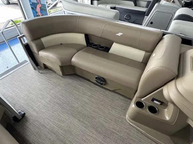 Slide: The Image of 2024 Starcraft LX 20 R boat interior with beige seating and cup holders. - 8