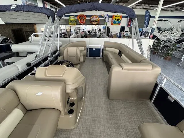 Slide: The Image of 2024 Starcraft LX 20 R pontoon boat interior with beige seating and modern design. - 9