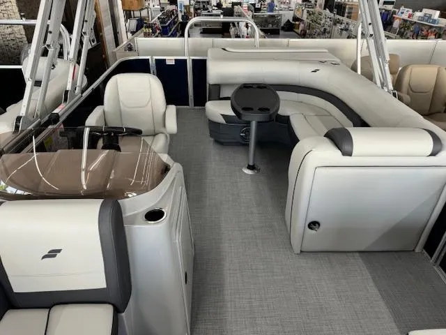 Slide: The Image of 2024 Starcraft EX 20 C pontoon boat interior with plush seating and modern helm. - 10