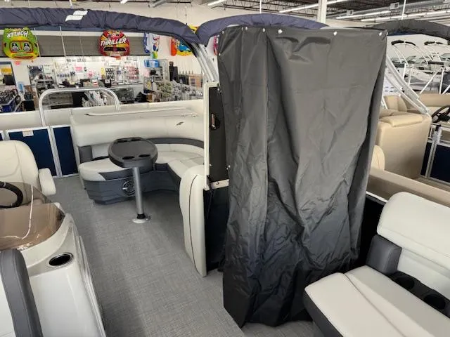 Slide: The Image of 2024 Starcraft EX 20 C pontoon boat interior with seating and privacy curtain. - 11