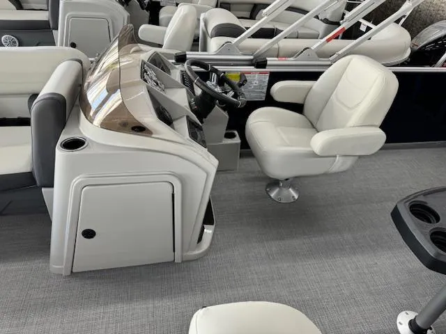 Slide: The Image of 2024 Starcraft EX 20 C boat interior with captain's chair and control console. - 12