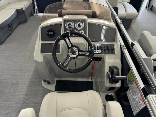 Slide: The Image of 2024 Starcraft EX 20 C boat dashboard with steering wheel and control panel. - 13