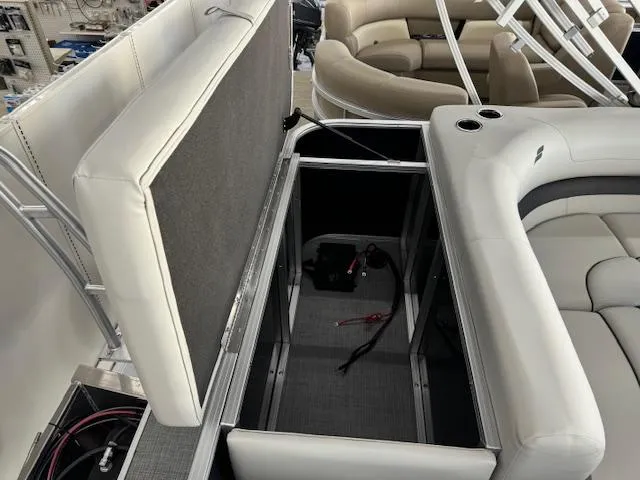 Slide: The Image of 2024 Starcraft EX 20 C pontoon boat with open storage compartment and seating area. - 16