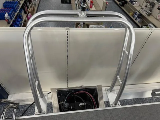 Slide: The Image of 2024 Starcraft EX 20 C pontoon boat ladder and engine compartment. - 18