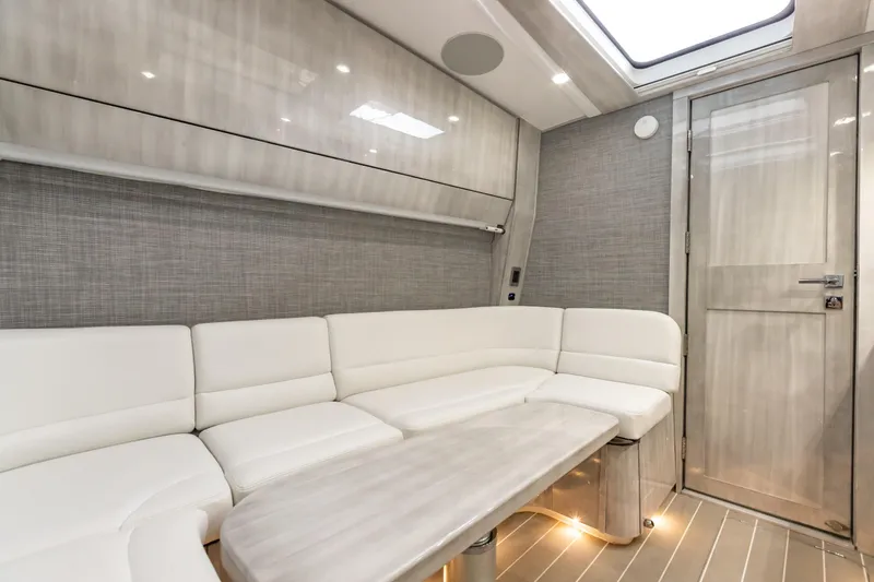 Slide: The Image of Interior of 2022 HCB 65 Estrella yacht with white leather seating and modern design. - 11
