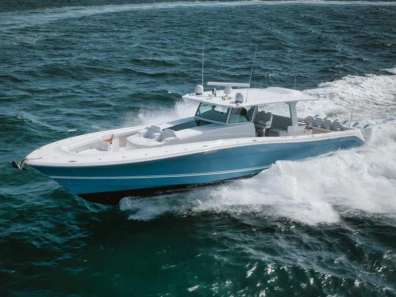 Slide: The Image of 2022 HCB 65 Estrella luxury boat cruising on open water. - 2