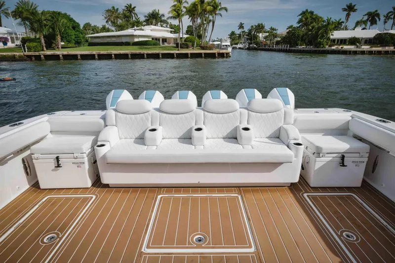 Slide: The Image of Luxury seating on the 2022 HCB 65 Estrella boat with scenic waterfront view. - 30