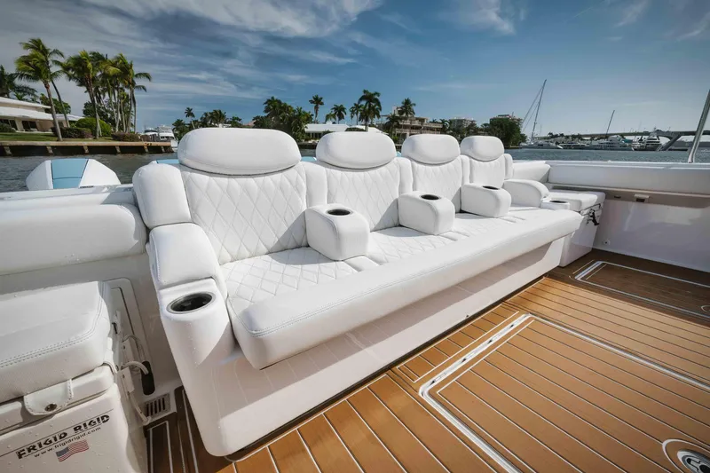 Slide: The Image of Luxury seating on the 2022 HCB 65 Estrella boat with white upholstery and cup holders. - 31