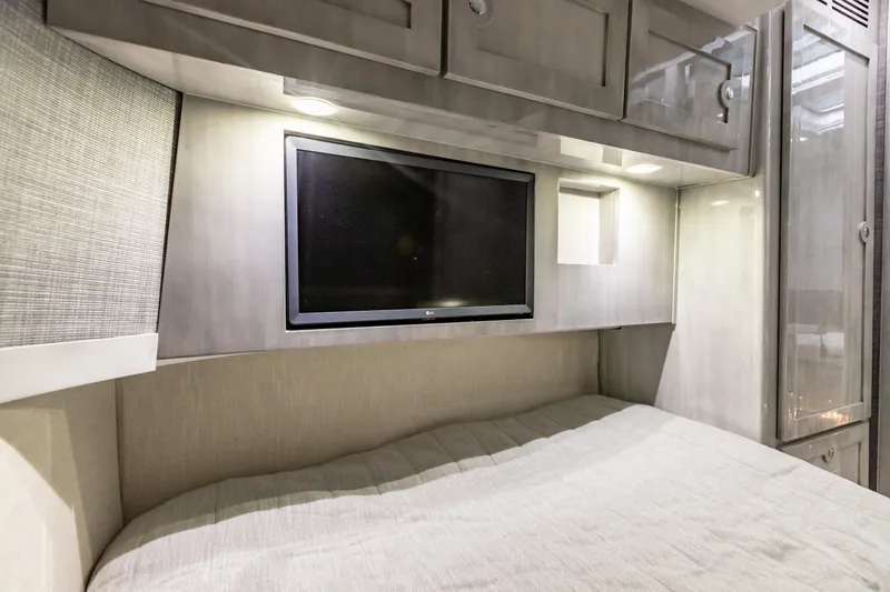 Slide: The Image of Interior of 2022 HCB 65 Estrella with TV and storage cabinets. - 35