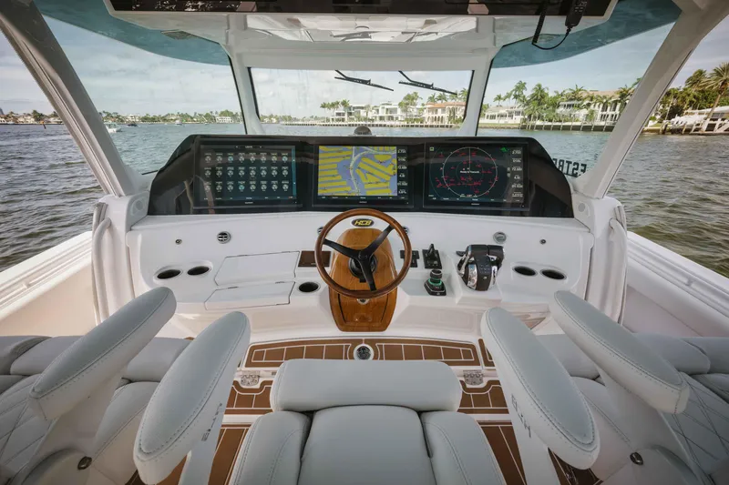 Slide: The Image of 2022 HCB 65 Estrella boat helm with advanced navigation screens and luxurious seating. - 36