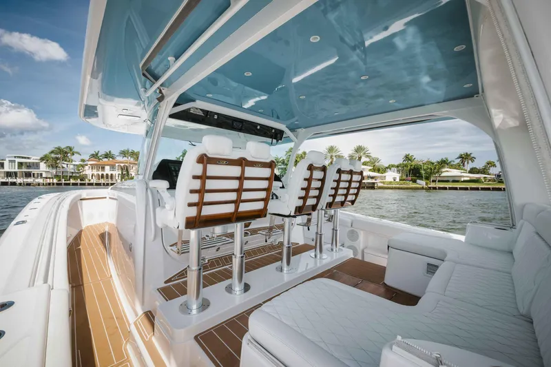 Slide: The Image of Interior of 2022 HCB 65 Estrella luxury boat with white seating and waterfront view. - 38