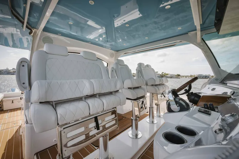 Slide: The Image of Interior of 2022 HCB 65 Estrella luxury boat with white leather seats and modern helm. - 41